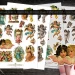 Three sheets of vintage angel-themed stickers are displayed, each featuring various cherubs and angels in different poses and outfits. These intricately designed ephemera pieces are perfect for fussy cutting, making them ideal for crafts or decorations. Scissors are placed nearby.
