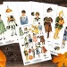 A flat lay of six sheets featuring vintage-style cut-out paper dolls in various costumes, including animals, fairy tale characters, and Halloween-themed outfits. A small pumpkin, pine cones, and autumn leaves adorn the wooden background.
