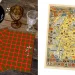 A wooden table displays two tartan cloths, one amber glass, one clear glass, and small white flowers. Adjacent is a colorful map of Scotland adorned with various clan crests and symbols. A "Clan Bruce Tartan" label is positioned on the upper left.
