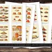 Four Victorian food collage sheets are laid out on a wooden surface. They depict various food items, including cakes, pies, bread, fruits, and vegetables, each image carefully illustrated with a vintage style. The sheets have the text "Victorian Food Collage Sheets JPG PDF Commercial Use" at the bottom.